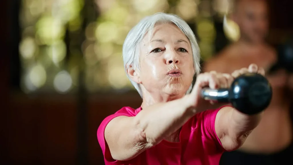 Woman doing resistance band exercises for toned arms Gosport 